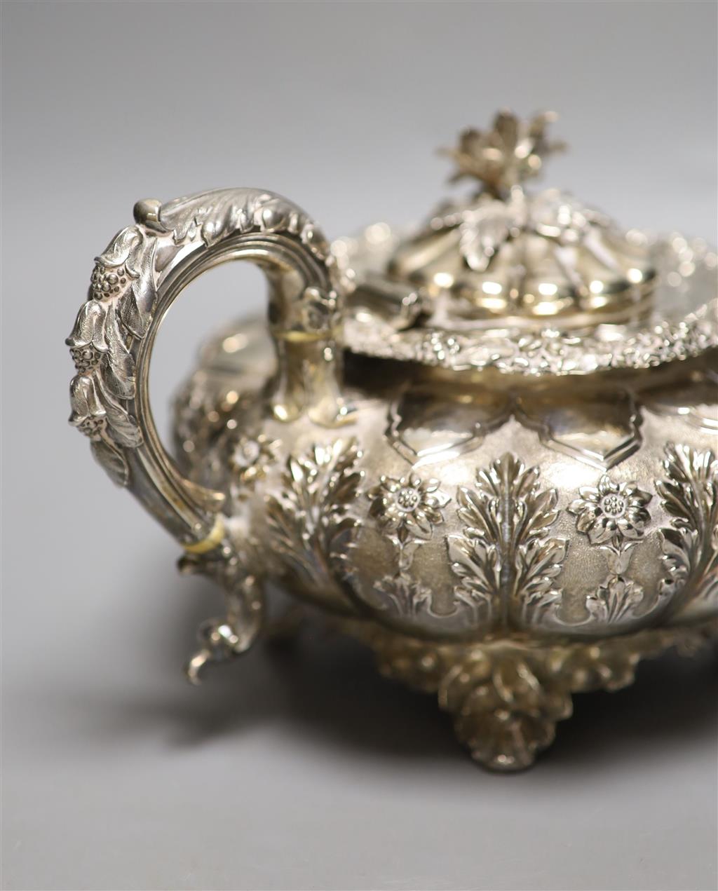 A George IV silver squat melon shaped teapot, embossed with flowers, The Barnards, London, 1829, gross 28oz.